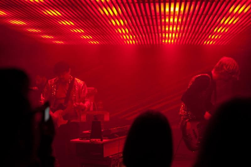 Live performance underneath neon lights.